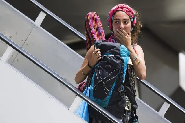 An Israeli evacuated from Nepal disembarks from an airplane after landing at Ben Gurion international airport near Tel Aviv, Israel April 28, 2015. (Photo by Amir Cohen/Reuters)