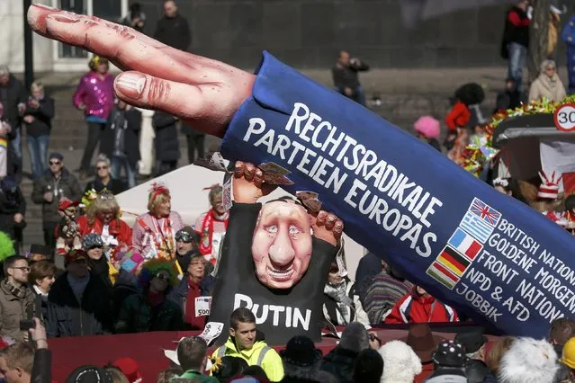 A carnival float with papier-mache caricature featuring featuring Russian President Vladimir Putin is displayed at a postponed “Rosenmontag” (Rose Monday) parade, at one location in Duesseldorf, Germany, March 13, 2016, after the original parade in February was cancelled due to severe weather. Words read “Radical right parties of Europe”. (Photo by Ina Fassbender/Reuters)