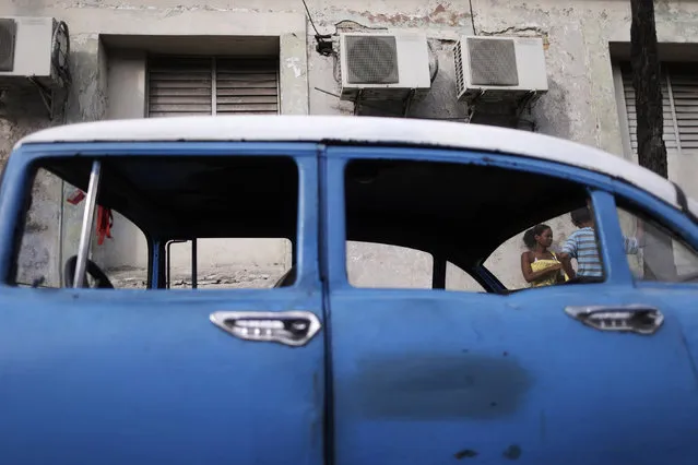 People are seen through the windows of a vintage car in Havana, Cuba March 18, 2016. (Photo by Ueslei Marcelino/Reuters)