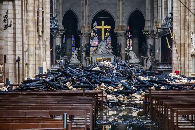 A hole is seen in the dome inside Notre Dame cathedral in Paris, Tuesday, April 16, 2019. Firefighters declared success Tuesday in a more than 12-hour battle to extinguish an inferno engulfing Paris' iconic Notre Dame cathedral that claimed its spire and roof, but spared its bell towers and the purported Crown of Christ. (Photo by Christophe Petit Tesson/Pool via AP Photo)