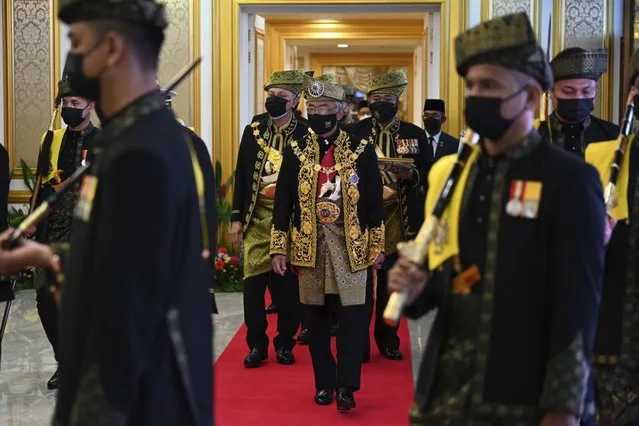 In this photo released by Malaysia's Department of Information, Malaysia's King Sultan Abdullah Sultan Ahmad Shah, center, arrives to the opening ceremony of the parliamentary session at the parliament house in Kuala Lumpur, Malaysia, Monday, September 13, 2021. (Photo by Nizam Zanil/Malaysia's Department of Information via AP Photo)