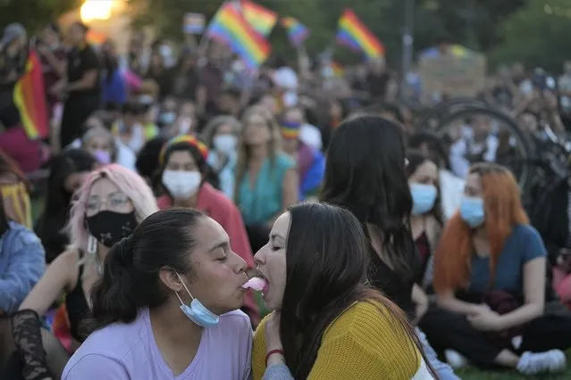 Jessica Morales, left, and Mitzy Pasten, members of the Movement for Homosexual Integration and Liberation, celebrate after lawmakers approved legislation legalizing marriage and adoption by same-s*x couples, in Santiago, Chile, Tuesday, December 7, 2021. (Photo by Esteban Felix/AP Photo)