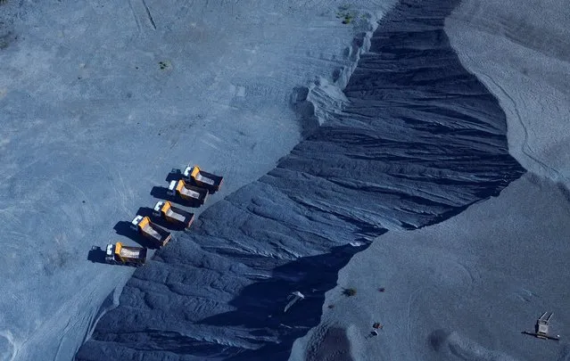 An aerial view of trucks waiting to load chrome at a mine in Marikana, outside Rustenburg, northwest of Johannesburg, South Africa, on March 14, 2024. (Photo by Siphiwe Sibeko/Reuters)