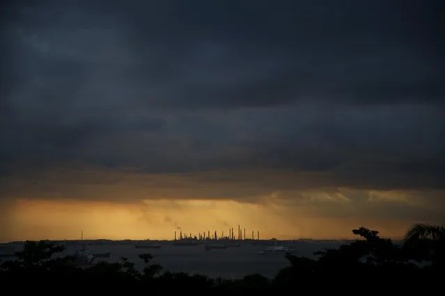 Storm clouds gather over Shell's Pulau Bukom oil refinery in Singapore January 30, 2016. (Photo by Edgar Su/Reuters)