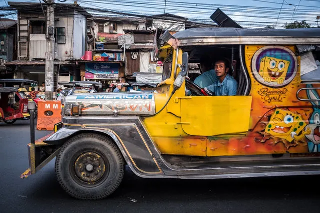 Manila is developing fast, and the jeepney is considered a dinosaur because of its old-fashioned look and diesel engine. (Photo by Claudio Sieber/Barcroft Media)