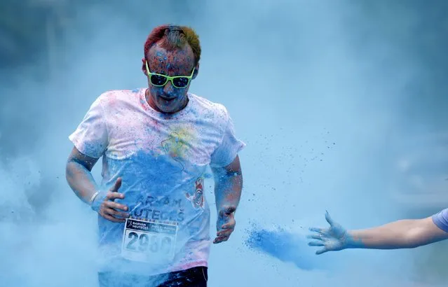 A participant runs through colored powder as he takes part in the Get Rainbowed run in Prague May 23, 2015. (Photo by David W. Cerny/Reuters)