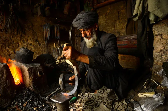 An Afghan blacksmith forges a tool at his workshop in Herat city on April 11, 2019. (Photo by Hoshang Hashimi/AFP Photo)