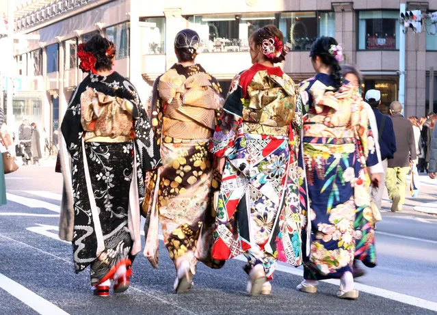 Twenty-year-old people in colorful kimono dresses walk at Ginza fashion district in Tokyo for the Coming-of-Age Day on Monday, January 9, 2023. (Photo by Yoshio Tsunoda/AFLO/Rex Features/Shutterstock)