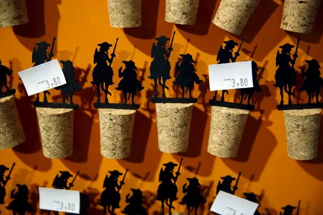 Don Quixote and Sancho Panza wine bottle corks are displayed for sale at the inn where locals believe Don Quixote might have been knighted in Puerto Lapice, Spain, April 8, 2016. (Photo by Susana Vera/Reuters)