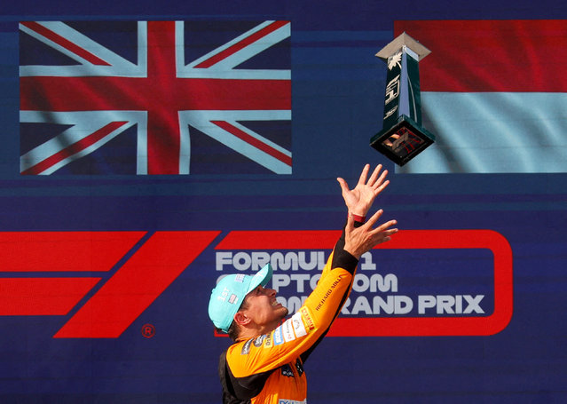 McLaren's Lando Norris celebrates winning the Miami Grand Prix on the podium with the trophy on May 5, 2024. (Photo by Brian Snyder/Reuters)
