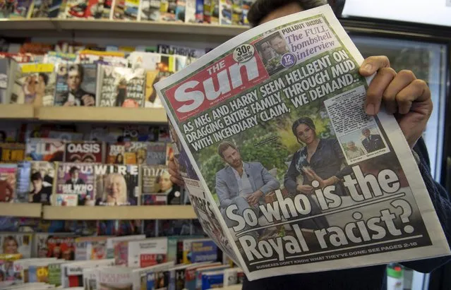 A man poses with a copy of the The Sun at a newspaper stand in London, Britain, 09 March 2021. US channel CBS aired a television interview with Britain's Harry and Meghan, Duke and Duchess of Sussex on 07 March. Buckingham Palace is yet to respond to racism allegations following the TV interview that was broadcast in the UK on 08 March. (Photo by Facundo Arrizabalaga/EPA/EFE)
