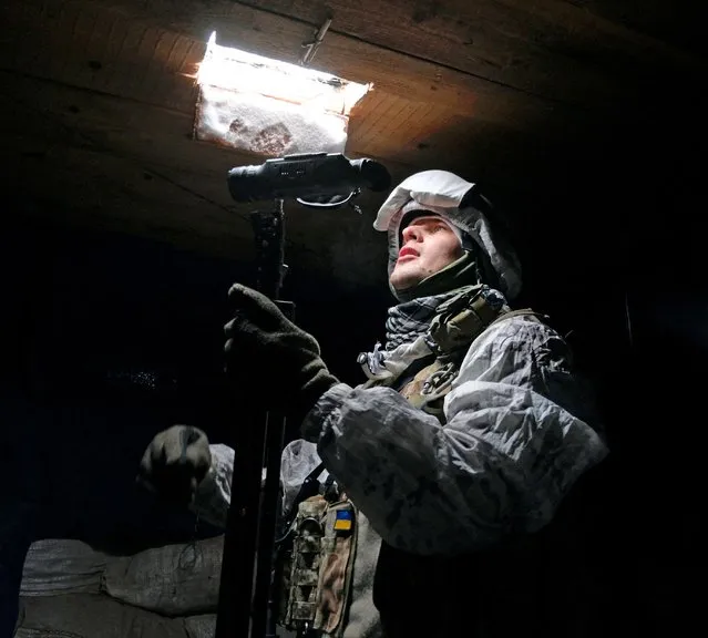 A service member of the Ukrainian armed forces is seen at combat positions near the line of separation from Russian-backed rebels outside the town of Avdiivka in Donetsk Region, Ukraine on January 25, 2022. (Photo by Maksim Levin/Reuters)