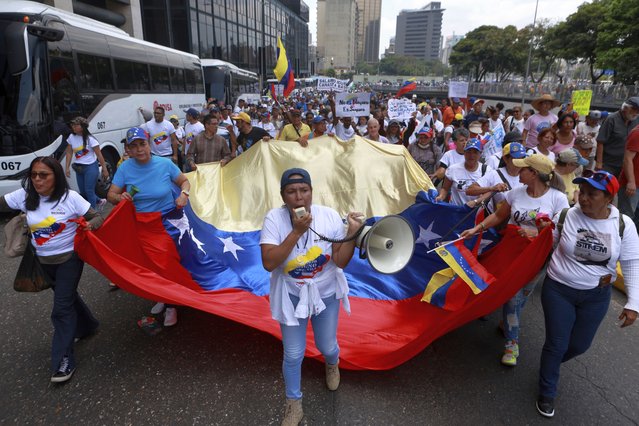Union workers march on International Workers' Day in Caracas, Venezuela, May 1, 2024. (Photo by Jesus Vargas/AP Photo)