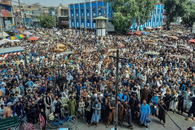 Afghan fans gather to watch the ICC T20 Cricket World Cup 2024 super eight match between Afghanistan and Bangladesh live broadcasting on a big screen at an intersection in Jalalabad on June 25, 2024. Afghanistan advanced to their first-ever T20 World Cup semi-final after completing a dramatic eight-run victory over Bangladesh in a rain-affected clash at the Arnos Vale Stadium in St Vincent on June 25. (Photo by AFP Photo/Stringer)