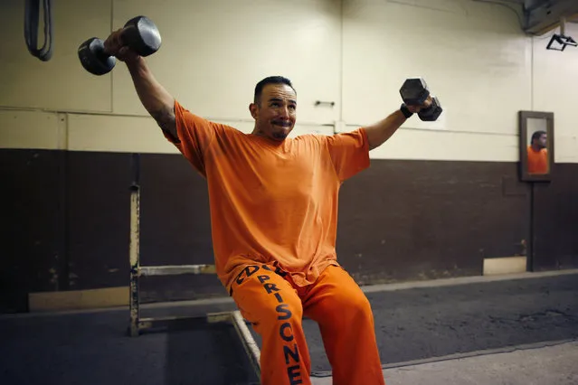 A prison inmate works out at Oak Glen Conservation Fire Camp #35 in Yucaipa, California November 6, 2014. Thousands of convicted felons form the backbone of California's wildfire protection force under a unique and little-known prison labor program. (Photo by Lucy Nicholson/Reuters)