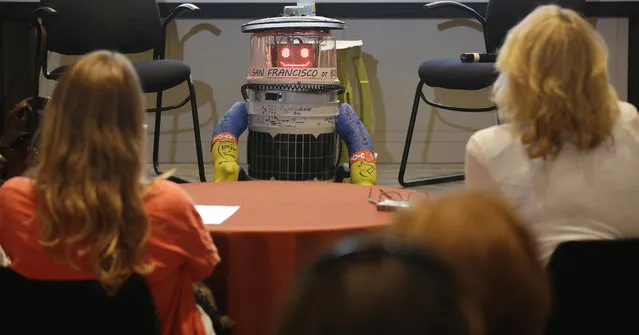 HitchBOT, a hitchhiking robot, is formally introduced to an American audience, during a program at the Peabody Essex Museum Thursday, July 16, 2015, in Salem, Mass. HitchBOT is set to embark on its' first cross-country hitchhiking trip of the U.S., after completing similar tips in Canada and Europe. The plans are for hitchBot to leave the Boston area Friday with a final destination goal of reaching San Francisco. (Photo by Stephan Savoia/AP Photo)
