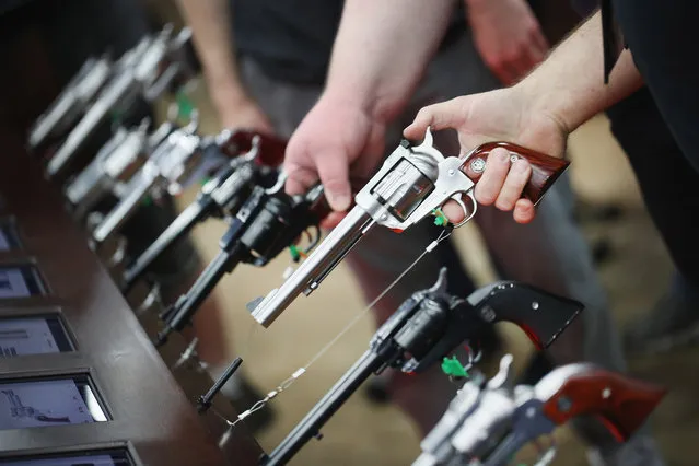 Gun enthusiasts look over Ruger pistols at the NRA Annual Meetings & Exhibits on May 21, 2016 in Louisville, Kentucky. (Photo by Scott Olson/Getty Images)