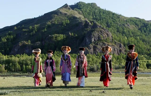 Models of the “Altyr” fashion theatre, dressed in Khakas national costumes, walk during a photo session, as a part of the rehearsal for the Tun-Pairam traditional holiday (The Holiday of the First Milk) celebration at a museum preserve outside Kazanovka village near Abakan in the Republic of Khakassia, Russia, May 28, 2016. (Photo by Ilya Naymushin/Reuters)