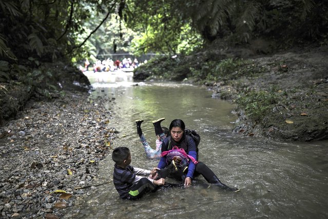 Venezuelan migrants rest during their walk across the Darien Gap from Colombia to Panama in hopes of reaching the U.S., Tuesday, May 9, 2023. Pandemic-related U.S. asylum restrictions, known as Title 42, are to expire Thursday, May 11. (Photo by Ivan Valencia/AP Photo)