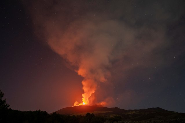 Lava flows from the Mount Etna volcano on the southern Italian island of Sicily near Catania on August 14, 2014. Mount Etna is one of the most active volcanoes in the world and is in an almost constant state of activity. (Photo by Marco Restivo/Etna Walk via Reuters)