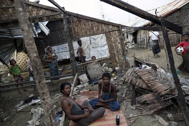 Rohingya people pass their time in a damaged shelter in Rohingya IDP camp outside Sittwe, Rakhine state on August 4, 2015. (Photo by Soe Zeya Tun/Reuters)