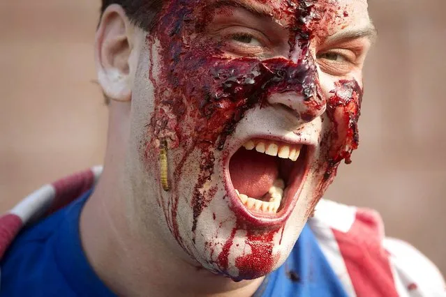 A participant of the “Zombie Takeover of Coney Island” poses for a portrait in Coney Island in the Brooklyn borough of New York, July 2, 2014. (Photo by Carlo Allegri/Reuters)