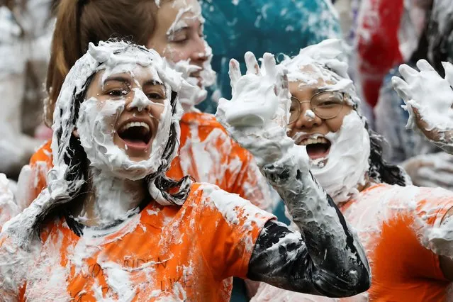 Students from St Andrews University are covered in foam as they take part in the traditional “Raisin Weekend” in the Lower College Lawn, at St Andrews in Scotland, Britain on October 18, 2021. (Photo by Russell Cheyne/Reuters)