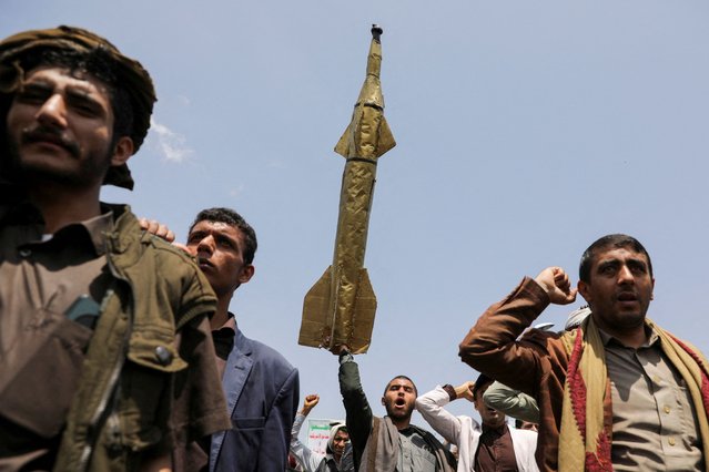 A student holds up a mock missile during a demonstration by students and university professors, mainly Houthi supporters, in solidarity with Palestinians at the campus of Sanaa University in Sanaa, Yemen on August 21, 2024. (Photo by Khaled Abdullah/Reuters)