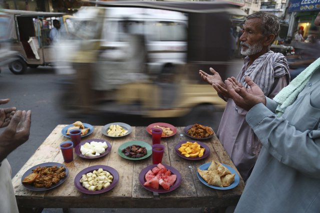 A picture made available on 20 June 2016 shows people praying as they wait to break the fast during the Muslim holy month of Ramadan, in Karachi, Pakistan, 19 June 2016. Muslims around the world celebrate the holy month of Ramadan by praying during the night time and abstaining from eating and drinking during the period between sunrise and sunset. Ramadan is the ninth month in the Islamic calendar and it is believed that the Koran's first verse was revealed during its last 10 nights. (Photo by Shahzaib Akber/EPA)