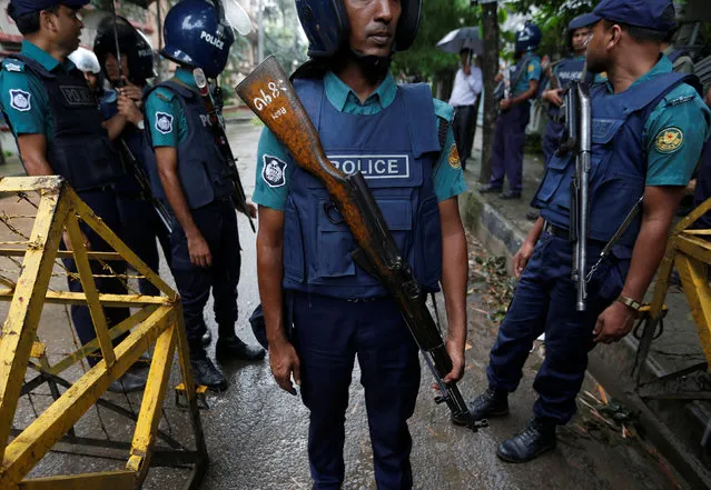 Policemen stand guard along a road leading to the Holey Artisan Bakery and the O'Kitchen Restaurant after gunmen attacked, in Dhaka, Bangladesh, July 3, 2016. (Photo by Adnan Abidi/Reuters)
