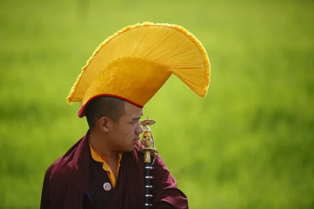 A Buddhist monk takes part in the funeral of Shamar Rinpoche in a monastery in Kathmandu July 31, 2014. Nepal has allowed a monk prominent in Tibetan Buddhism to be cremated in a monastery in Kathmandu, a minister said on Tuesday, disregarding fears of possible anti-China protests by his followers during the funeral. (Photo by Navesh Chitrakar/Reuters)