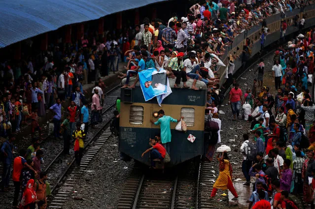 People sit atop an overcrowded passenger train as they travel home to celebrate Eid al-Fitr festival, which marks the end of the Muslim holy fasting month of Ramadan, at a railway station in Dhaka, Bangladesh, July 5, 2016. (Photo by Adnan Abidi/Reuters)