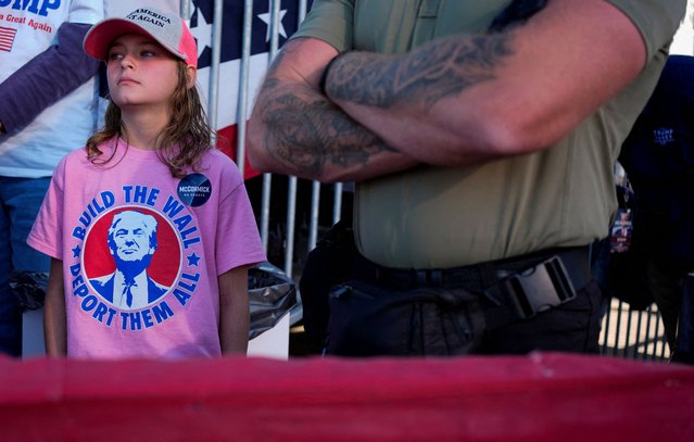 A girl wearing a "Build the wall, deport them all" t-shirt attends Donald Trump's Make America Great Again Rally in Latrobe, Pennsylvania, on October 19, 2024. (Photo by Brian Snyder/Reuters)