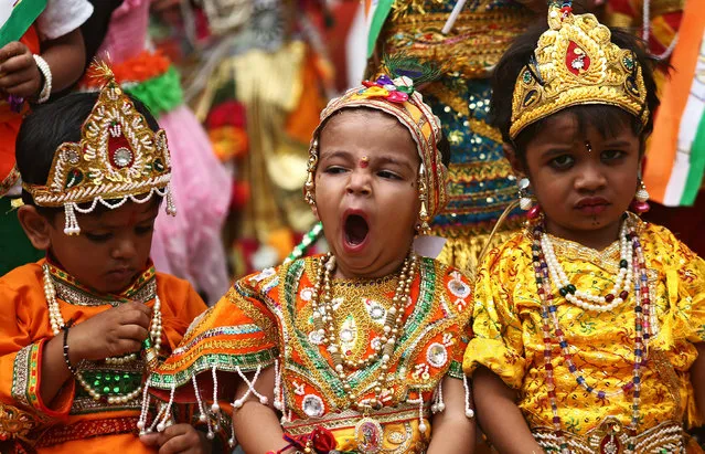 School children dressed as Hindu Lord Krishna, wait to perform during the celebrations ahead of the Janmashtami festival, which marks the birth anniversary of Lord Krishna in Ajmer, India, August 14, 2017. (Photo by Himanshu Sharma/Reuters)