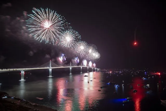 Fireworks illuminate skies over the newly built Peljesac Bridge in Komarna, southern Croatia, Tuesday, July 26, 2022. Croatia is marking the opening of a key and long-awaited bridge connecting two parts of the country's Adriatic Sea coastline while bypassing a small part of Bosnia's territory. (Photo by AP Photo)