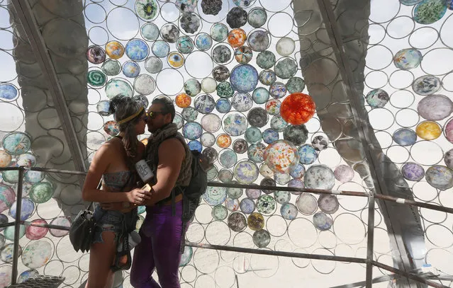 Participants Solene, left and Daniel kiss as approximately 70,000 people from all over the world gathered for the annual Burning Man arts and music festival in the Black Rock Desert of Nevada, U.S. on  on August 31, 2017. (Photo by Jim Urquhart/Reuters)