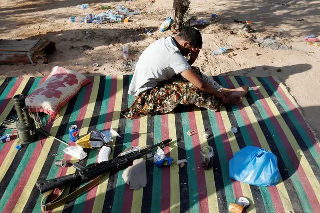 A member of the Libyan forces allied with the U.N.-backed government takes a break at the frontline in Sirte, Libya, July 18, 2016. (Photo by Goran Tomasevic/Reuters)