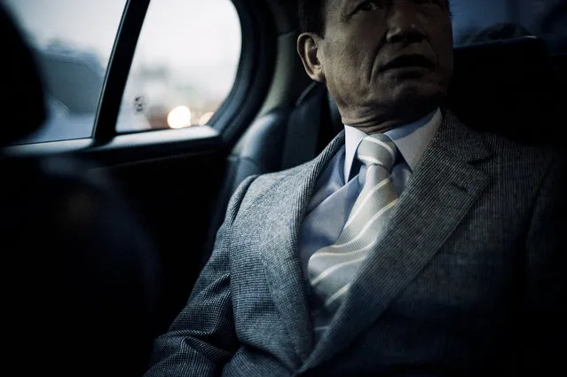 Nitto-san, Souichirou's direct boss, in the back of the car, while driving to Niigata prison to go and pick up two members of the family that are being released from prison that morning, after being incarcerated for several years – 2009. (Photo and caption by Anton Kusters)