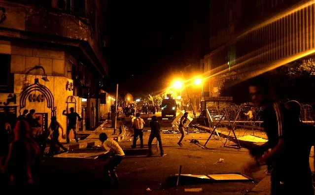 In Cairo, protesters clash with police in front of the U.S. embassy early Thursday, as part of widespread anger across the Muslim world about a film ridiculing Islam's Prophet Muhammad. (Photo by Mohammed Abu Zaid/Associated Press)