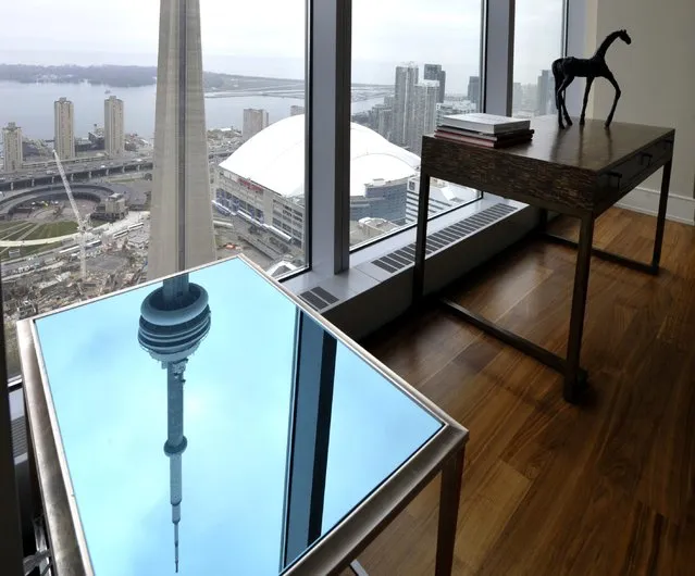 The CN Tower is reflected on an end table in the dining room of the Ritz Carlton residents model suite in Toronto, Ontario, Canada on May 1, 2012. (Photo by Mike Cassese/Reuters)