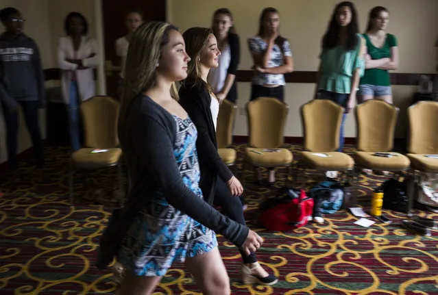 Madisyn Martinelli, 12, of New Milford, Conn., and Heather Duenas, 14, of Stafford, Va., practice their runway walk at a modeling camp at the Courtyard Marriott Hotel in McLean, Va., on Tuesday, August 18th, 2015. (Photo by Brittany Greeson/The Washington Post)