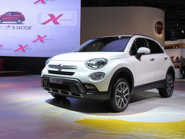 The Fiat 500 X is unveiled at the Paris Auto Show in front of the Fiat 500 wooden prototype on October 2, 2014 on the first of the two press days. (Photo by Eric Piermont/AFP Photo)