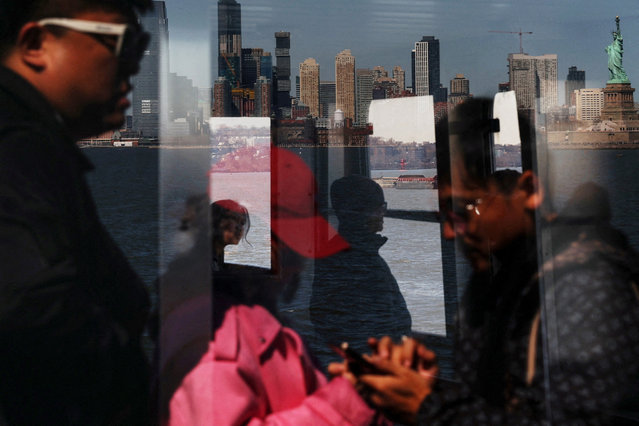 The Statue of Liberty is seen reflected from aboard the Staten Island Ferry in New York City on March 18, 2025. Picture taken through glass. (Photo by Shannon Stapleton/Reuters)