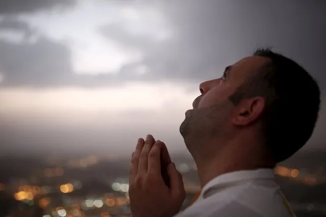 A Muslim pilgrim prays as he visits Hera cave, where Muslims believe Prophet Mohammad received the first words of the Koran through Gabriel, at the top of Mount Al-Noor during the annual haj pilgrimage in the holy city of Mecca, September 21, 2015. (Photo by Ahmad Masood/Reuters)