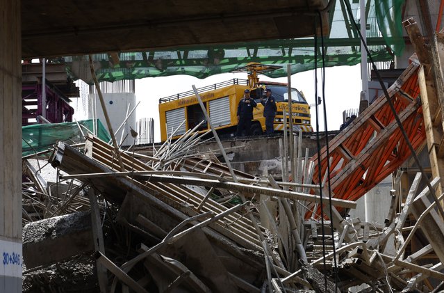 Expressway Authority of Thailand officers look at the scene of an accident at an under-construction expressway, in Bangkok, Thailand, 15 March 2025. A concrete beam of an under-construction expressway bridge collapsed and killed five workers and injured at least 27 people, according a statement from the Royal Thai Police. (Photo by Narong Sangnak/EPA)