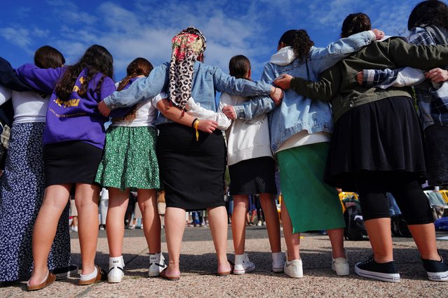 Israeli teenagers sing the national anthem, as faculty and representatives from the University of Pennsylvania visit a plaza, in support of the families of hostages kidnapped on the October 7 attack, in Tel Aviv, Israel on January 4, 2024. (Photo by Alexandre Meneghini/Reuters)