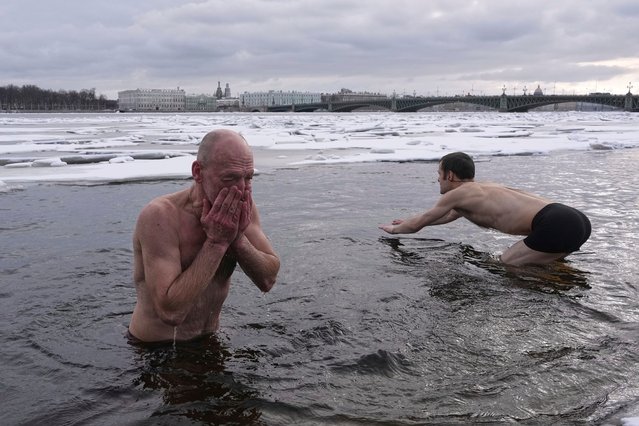 Men swim in the icy water of the Neva River in St. Petersburg, Russia, Friday, March 14, 2025. (Photo by Dmitri Lovetsky/AP Photo)