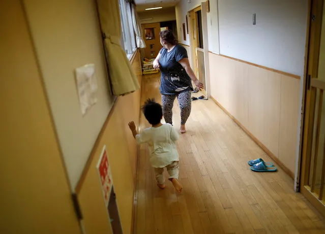 A child plays with a nurse at Futaba Baby Home in Tokyo, Japan, June 21, 2016. (Photo by Issei Kato/Reuters)