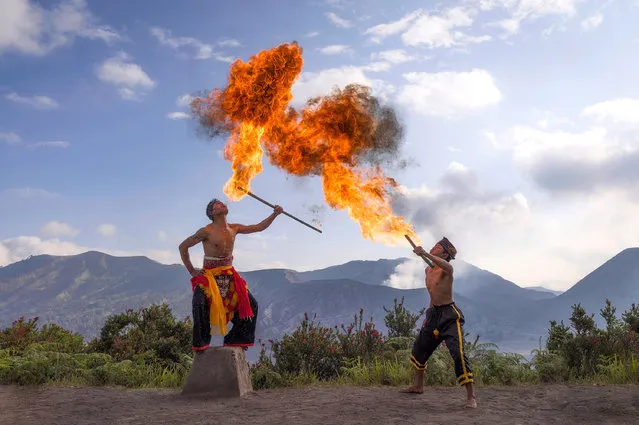 Indonesian dancers perform a dance called the Reog which sees them fire breathing around an active volcano. Hilton Chen photographed the Tengger People on the caldera of Mount Bromo in East Java in the first decade of December 2022. (Photo by Hilton Chen/Solent News & Photo Agency)