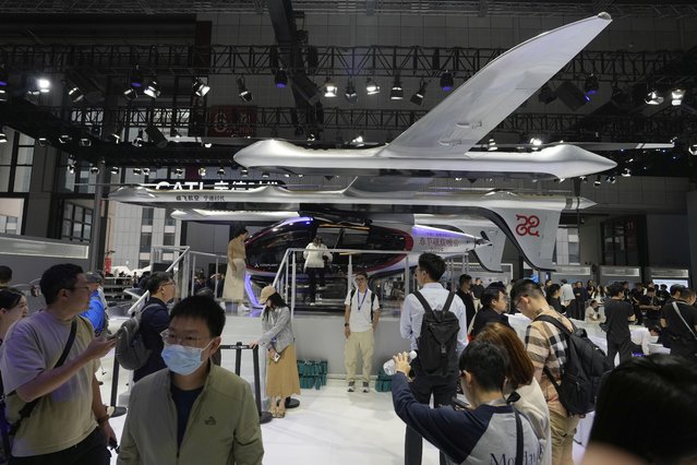 Visitors stand near a flying test platform from Chinese battery manufacturer CATL during the Shanghai auto show on Wednesday, April 23, 2025. (Photo by Ng Han Guan/AP Photo)